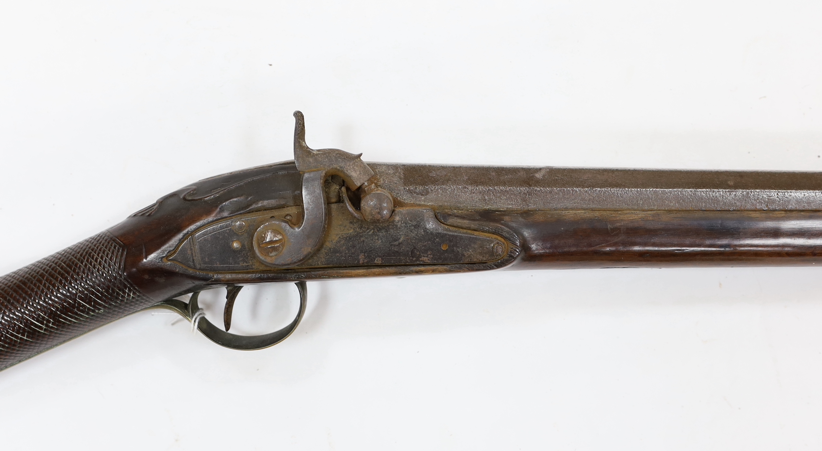 A 1786 percussion 12 bore fowling piece, converted from flintlock, with a fully stocked half octagonal barrel, London proofs, brass furniture and sideplate engraved IR 1786, chequered grip and wooden ramrod, barrel 96cm
